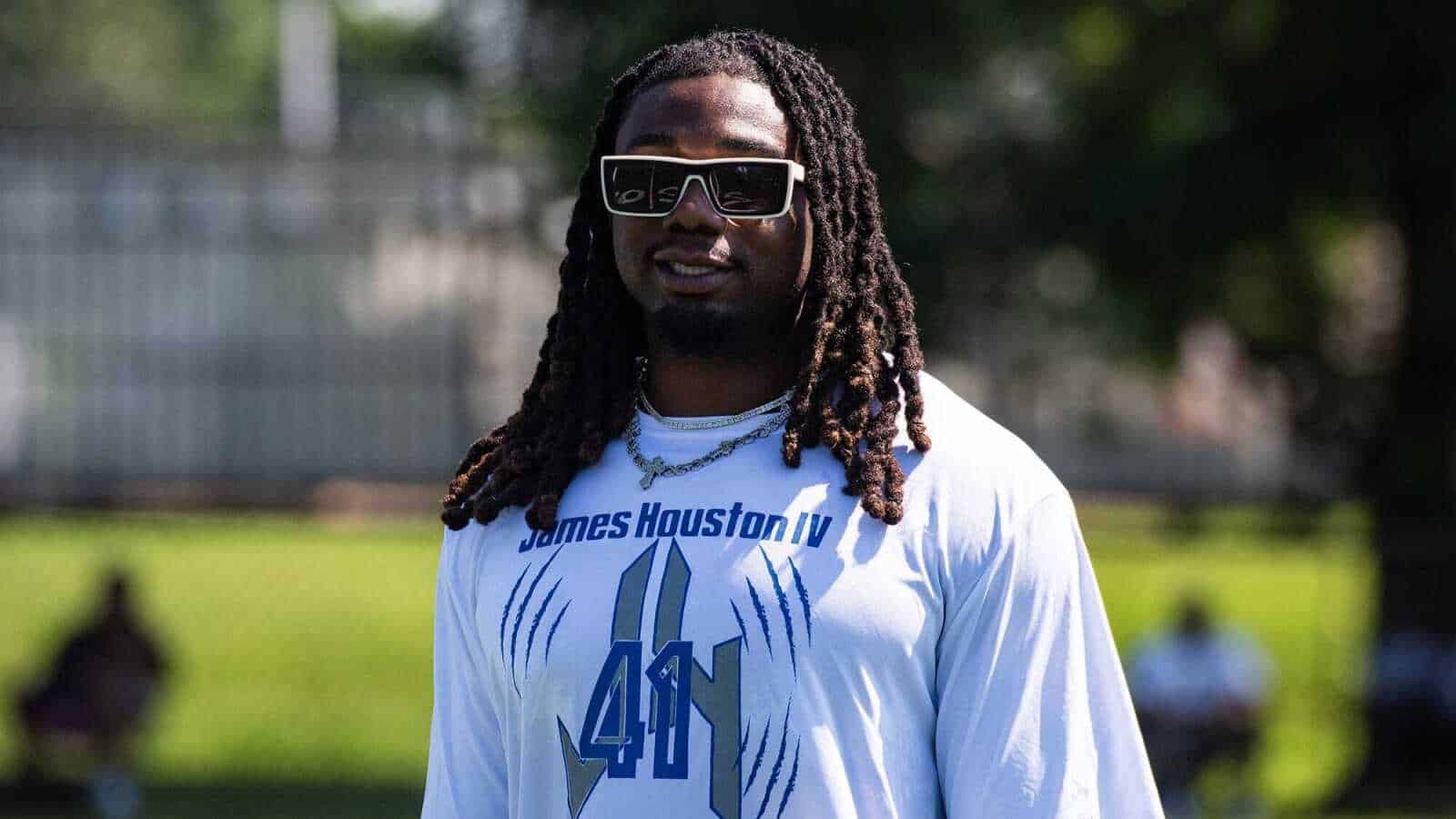 James Houston IV wearing sunglasses and a white Dallas Cowboys shirt during practice.