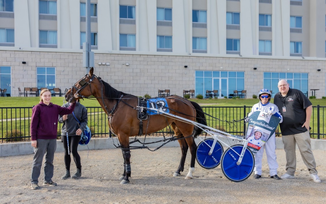 Luke Plano was presented with a Congratulatory banner in the Winner's Circle for his $20 million milestone