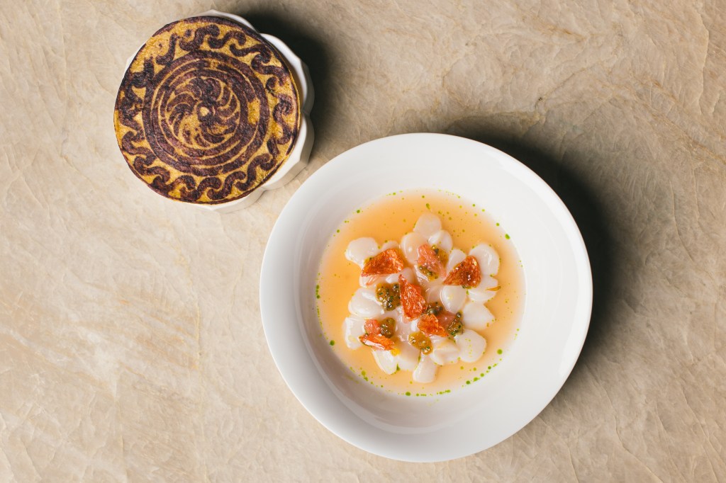 two plates on a table, one with a tortilla, another with crudo