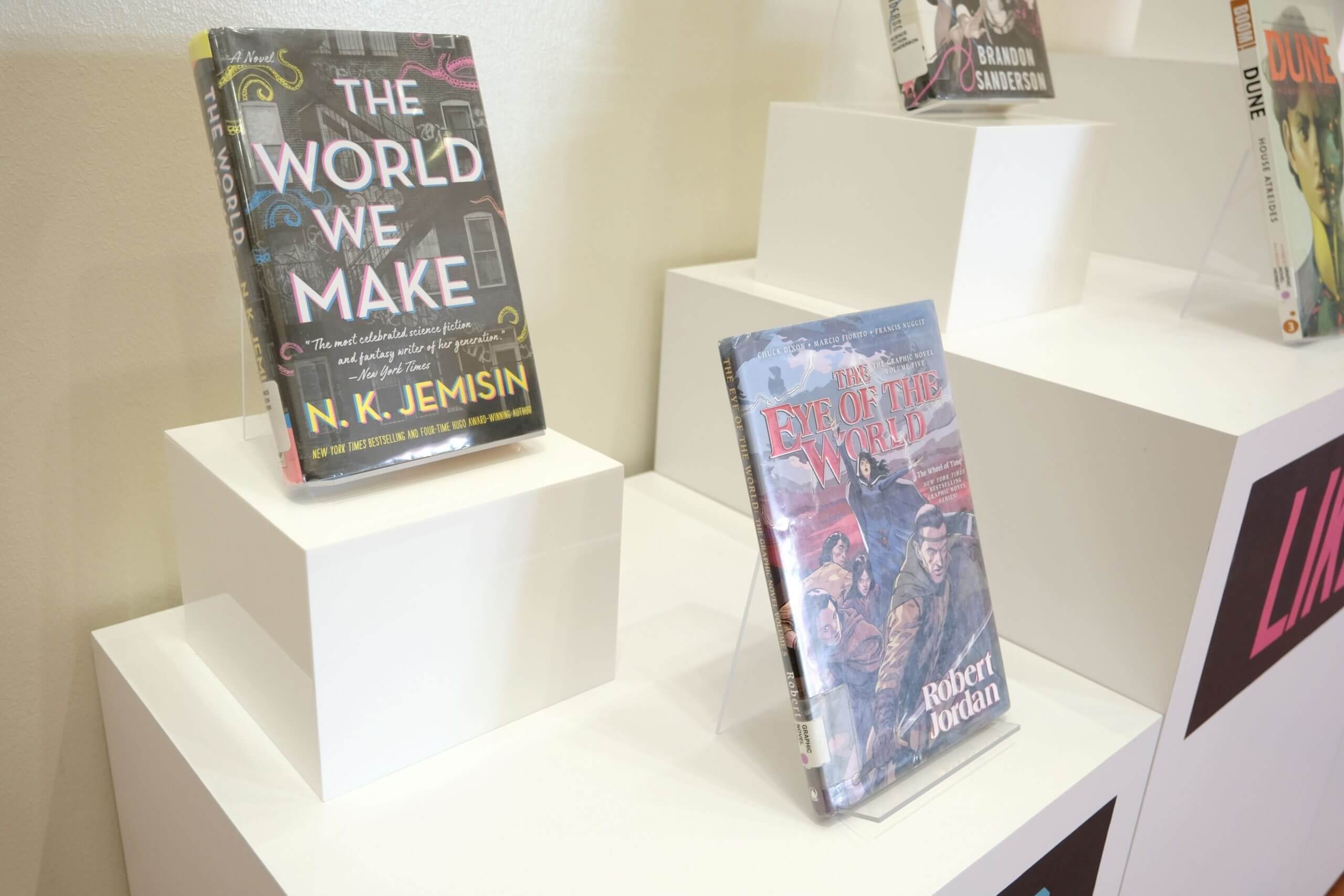 Close-ups of some of Victor Wembanyama's favorite books elevated on a white display at the library.