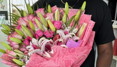 Someone holds a bouquet of pink flowers