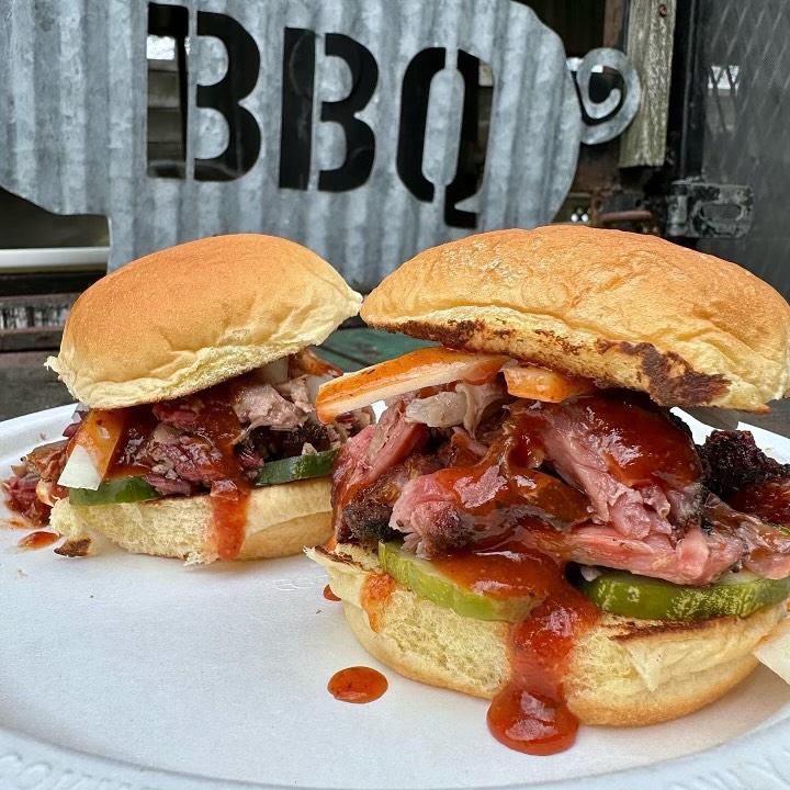 Image shows a couple barbecue sandwiches offered at Tejas Barbecue + Chocolate. 