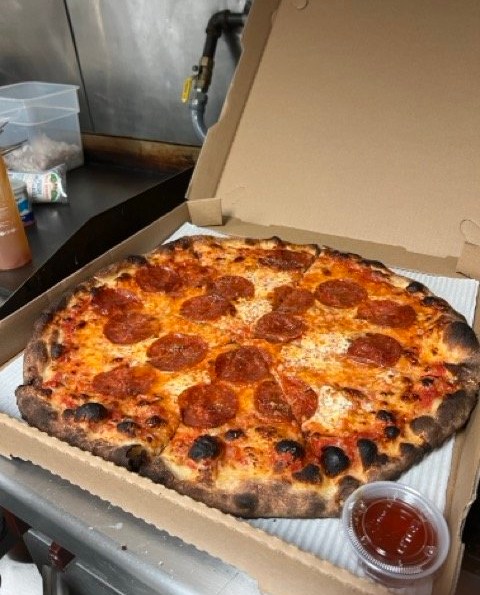 A pepperoni pizza in a box at Small’s Pizza.
