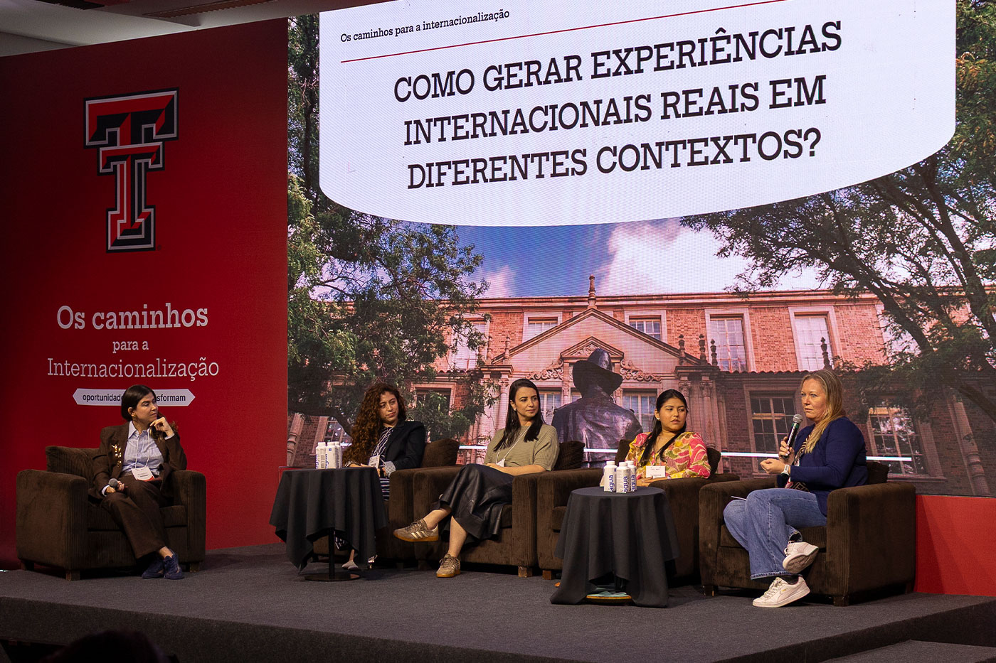Five women seated on a stage interview-style