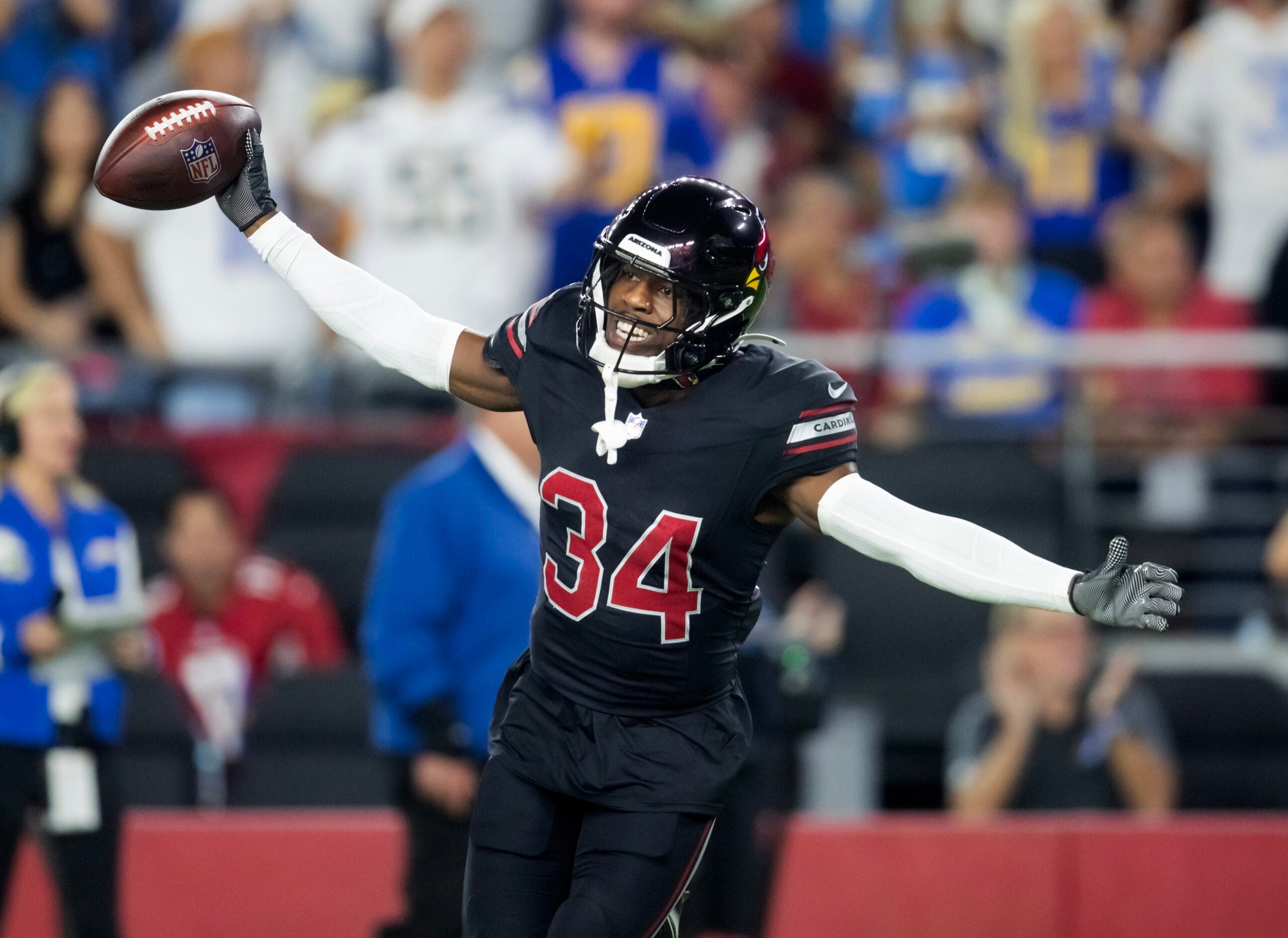 Oct 21, 2024; Glendale, Arizona, USA; Arizona Cardinals safety Jalen Thompson (34) celebrates after recovering a fumble from the Los Angeles Chargers in the first half at State Farm Stadium.