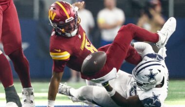 Oct 19, 2025; Arlington, Texas, USA; Washington Commanders quarterback Jayden Daniels (5) fumbles the ball defended by Dallas Cowboys linebacker Shemar James (50) during the third quarter of the game at AT&T Stadium.