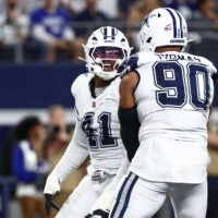 Oct 19, 2025; Arlington, Texas, USA; Dallas Cowboys defensive end Donovan Ezeiruaku (41) and defensive end Solomon Thomas (90) celebrate after a sack against the Washington Commanders during the fourth quarter of the game at AT&T Stadium.