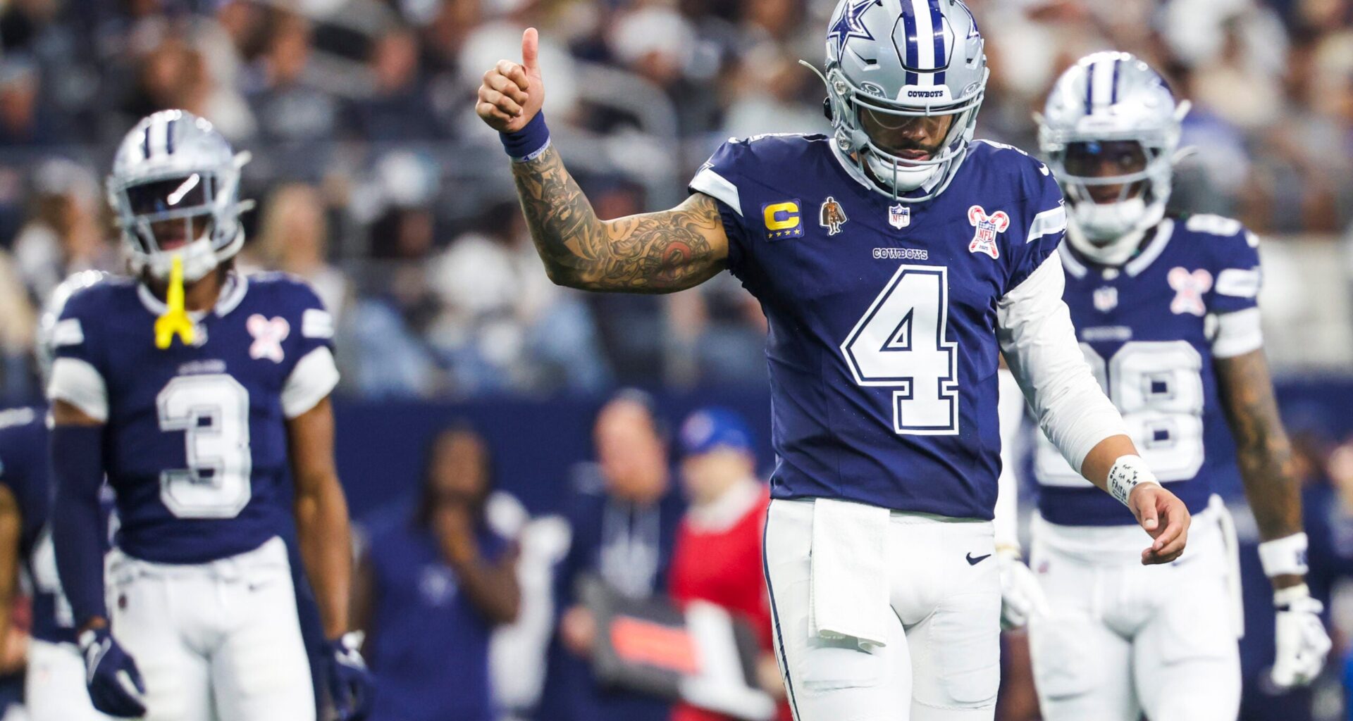 Dec 21, 2025; Arlington, Texas, USA; Dallas Cowboys quarterback Dak Prescott (4) signals towards the sideline following a play against the Los Angeles Chargers during the third quarter at AT&T Stadium.