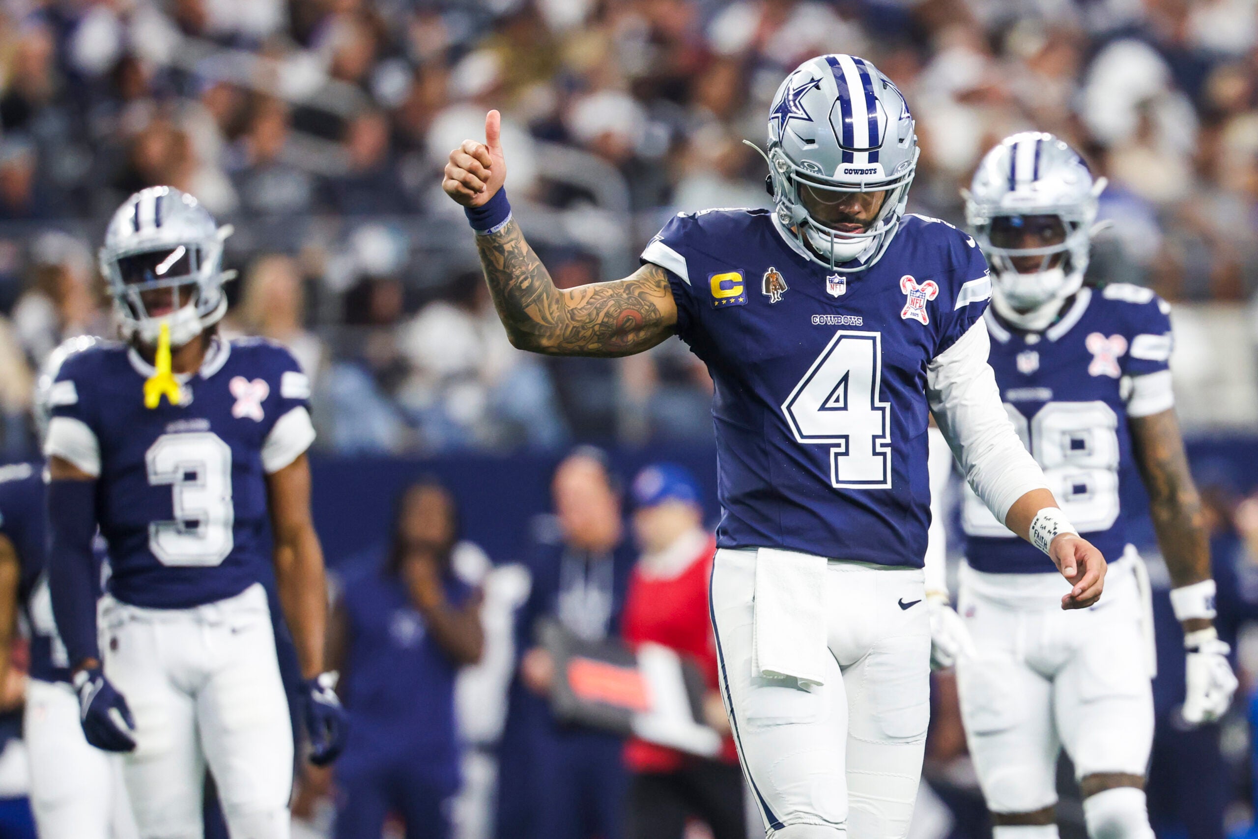 Dec 21, 2025; Arlington, Texas, USA; Dallas Cowboys quarterback Dak Prescott (4) signals towards the sideline following a play against the Los Angeles Chargers during the third quarter at AT&T Stadium.
