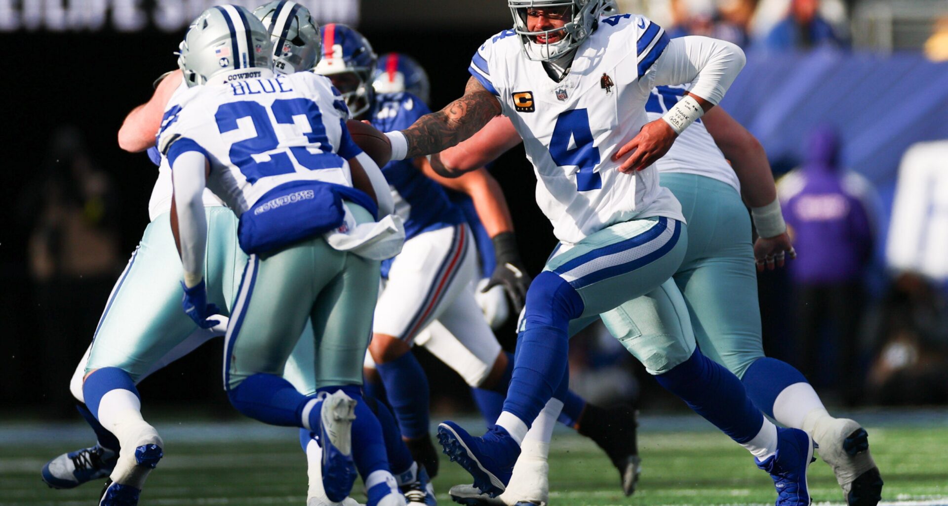Jan 4, 2026; East Rutherford, New Jersey, USA; Dallas Cowboys quarterback Dak Prescott (4) hands the ball off to Dallas Cowboys running back Jaydon Blue (23) during the second quarter against the New York Giants at MetLife Stadium.