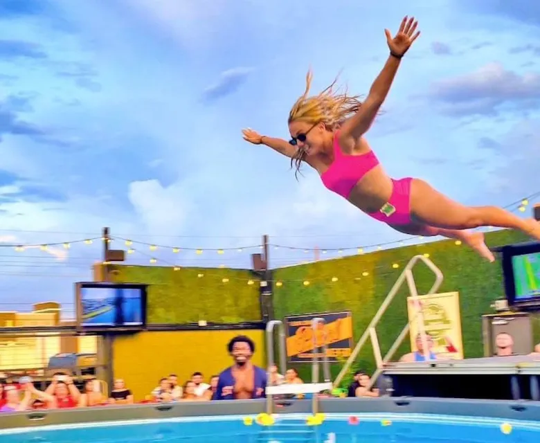 A contestant aims for a big splash during Little Woodrow's 2025 No Flips, All Flops’ Belly Flop Contest.