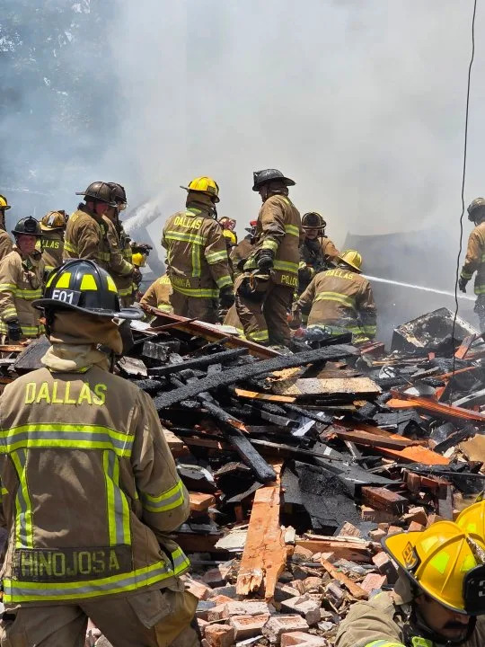 Dallas Fire-Rescue crews search through debris after an apartment explosion and four-alarm fire at 409 E. 9th St. in Dallas on Wednesday. Officials said the fire was under control as the incident remained ongoing. (Dallas Fire-Rescue via X)