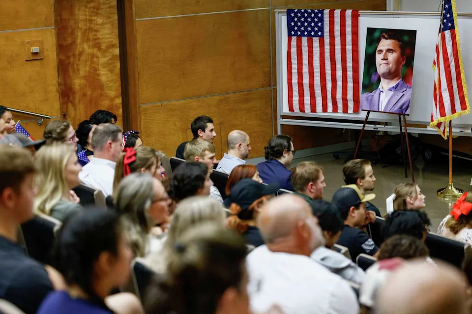 Attendees listen to a eulogy during a memorial for Charlie Kirk hosted by The University of Texas at Dallas chapter of Turning Point USA, Wednesday, Sept. 17, 2025, in Richardson. (Elías Valverde II/Staff Photographer)