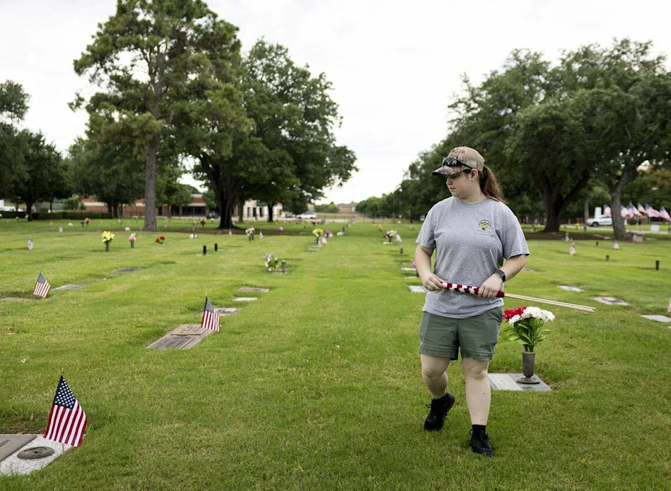 Kara Jakubik, 17, with Scouting America, searches for veterans’ graves at Bluebonnet Hills Funeral Home & Memorial Park ahead of Memorial Day on Saturday, May 23, 2026 in Colleyville, Texas.