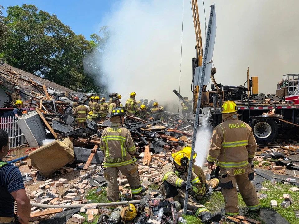 Dallas Fire-Rescue crews search through debris after an apartment explosion and four-alarm fire at 409 E. 9th St. in Dallas on Wednesday. Officials said the fire was under control as the incident remained ongoing. (Dallas Fire-Rescue via X)