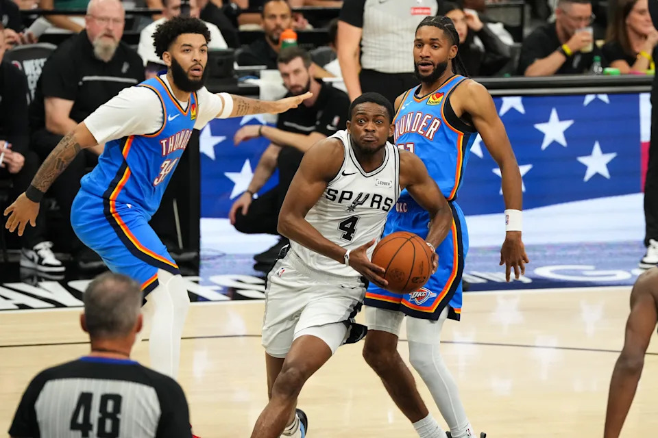 May 24, 2026; San Antonio, Texas, USA; San Antonio Spurs guard De'Aaron Fox (4) drives the ball past Oklahoma City Thunder guard Isaiah Joe (11) in the fourth quarter during game four of the western conference finals for the 2026 NBA playoffs at Frost Bank Center. Mandatory Credit: Scott Wachter-Imagn Images