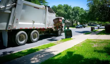 trash truck picking up in a neighborhood