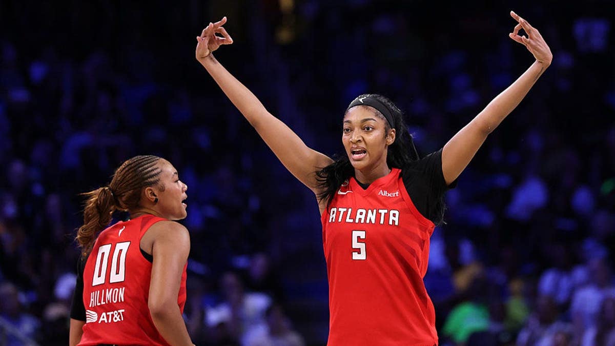 Angel Reese of the Atlanta Dream celebrates a three-point shot during a basketball game.