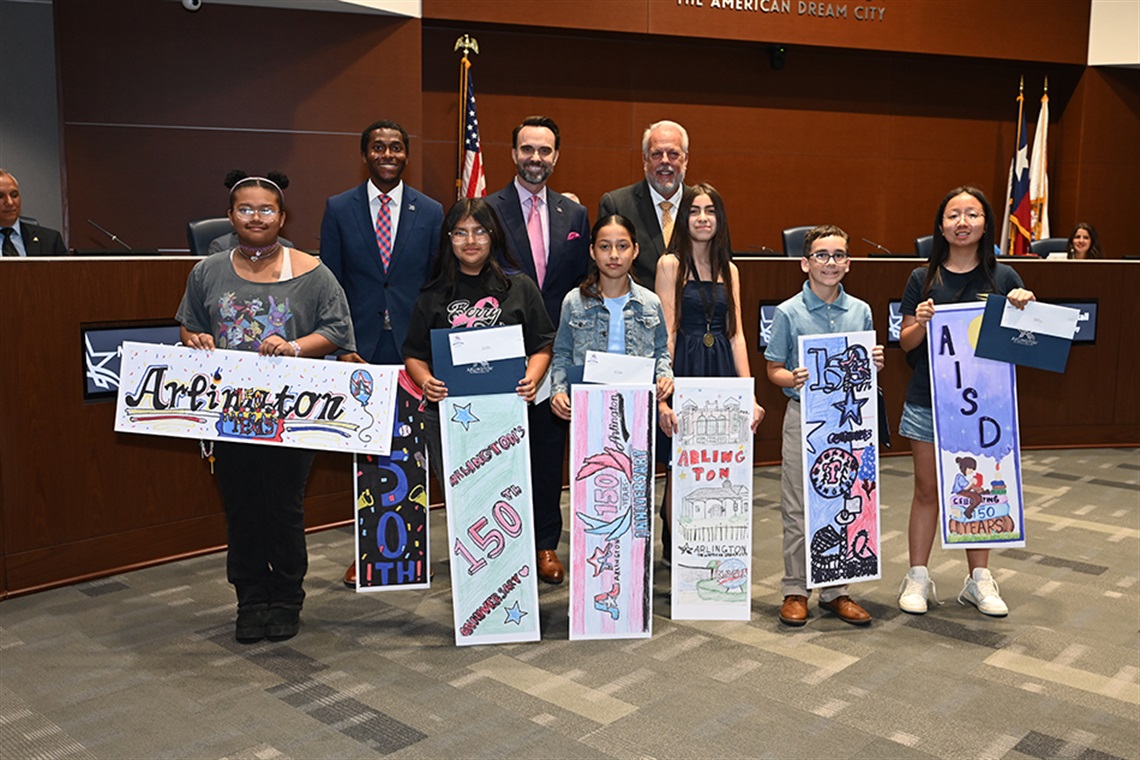 Sixth grade students from AISD hold up bookmark displays after winning a contest.