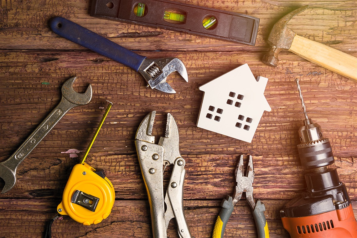 An assortment of tools on a wooden table. 