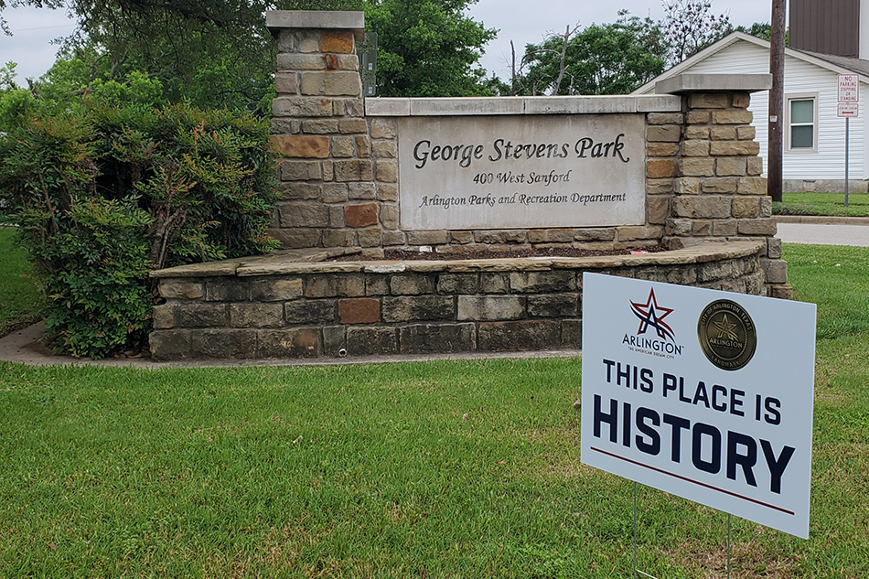 Sign in front of park signage that reads 