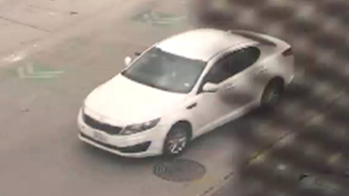 White Kia sedan parked on a street believed stolen in Austin shootings