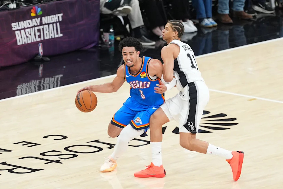 May 24, 2026; San Antonio, Texas, USA; Oklahoma City Thunder guard Jared McCain (3) drives the ball past San Antonio Spurs forward Carter Bryant (11) in the third quarter during game four of the western conference finals for the 2026 NBA playoffs at Frost Bank Center. Mandatory Credit: Daniel Dunn-Imagn Images