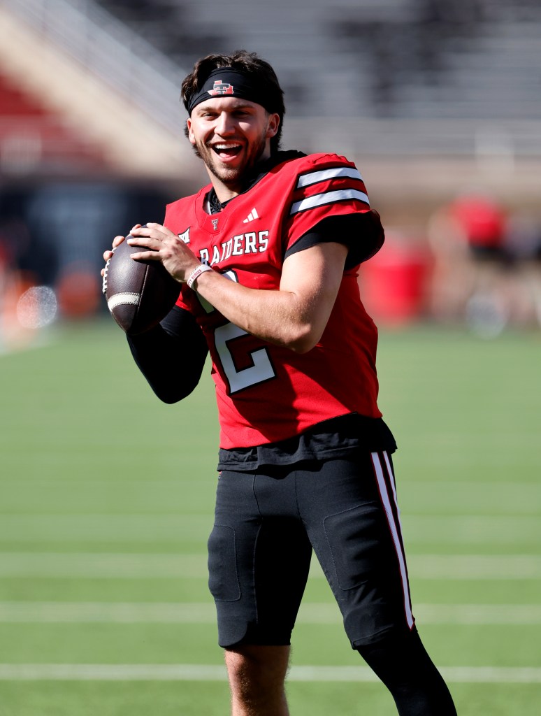 Brendan Sorsby #2 of the Texas Tech Red Raiders smiles while holding a football.