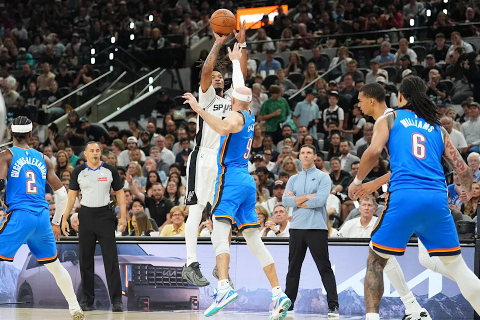 May 24, 2026; San Antonio, Texas, USA; San Antonio Spurs guard Stephon Castle (5) shoots while defended by Oklahoma City Thunder guard Alex Caruso (9) in the first quarter during game four of the western conference finals for the 2026 NBA playoffs at Frost Bank Center. Mandatory Credit: Daniel Dunn-Imagn Images