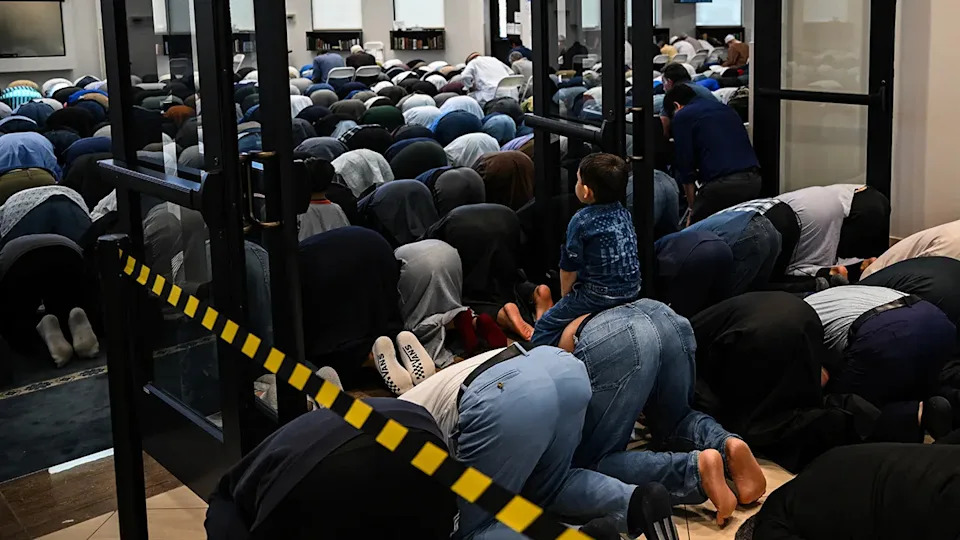Muslim men praying inside a mosque in Plano, Texas