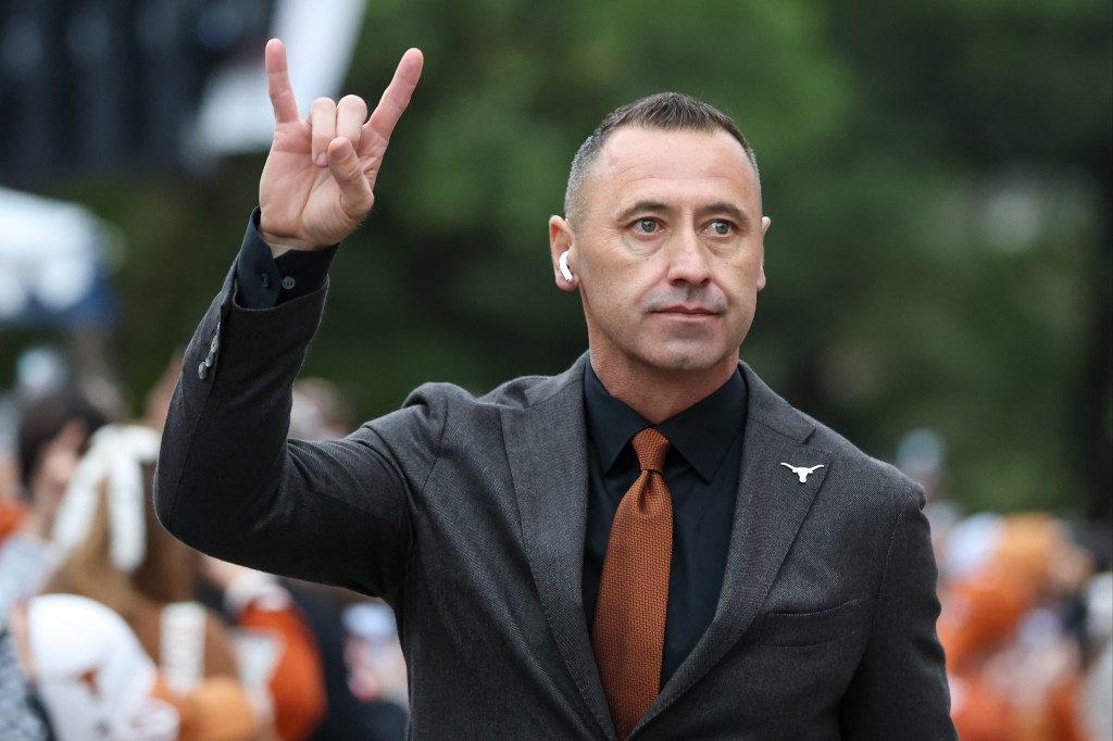 Head coach Steve Sarkisian of the Texas Longhorns holds Horns Up as he walks into the stadium before the SEC football game between Texas Longhorns and Texas A&M Aggies on November 28, 2025, at Darrell K Royal-Texas Memorial Stadium in Austin, TX.