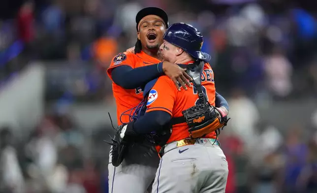 Houston Astros pitcher Alimber Santa, left, reacts with catcher Christian Vázquez after completing their team's combine no-hitter win over the Texas Rangers during a baseball game Monday, May 25, 2026, in Arlington, Texas. (AP Photo/Julio Cortez)