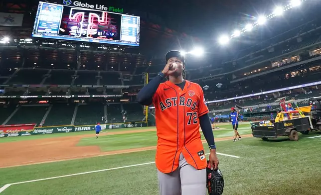 Houston Astros pitcher Alimber Santa kisses the ball after he helped his team earn a combined no-hitter during his major league debut in a baseball game against the Texas Rangers, Monday, May 25, 2026, in Arlington, Texas. (AP Photo/Julio Cortez)