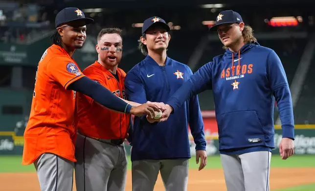 Houston Astros pitchers Alimber Santa, left, Houston Astros starting pitcher Tatsuya Imai throws to the Texas Rangers, center right, and Steven Okert, right, pose with catcher Christian V·zquez after combining for a no-hitter against the Texas Rangers during a baseball game Monday, May 25, 2026, in Arlington, Texas. (AP Photo/Julio Cortez)