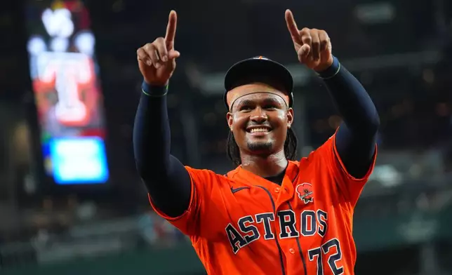 Houston Astros pitcher Alimber Santa gestures after pitching in his major league debut and closing a combined no-hitter by his team against the Texas Rangers during a baseball game Monday, May 25, 2026, in Arlington, Texas. (AP Photo/Julio Cortez)