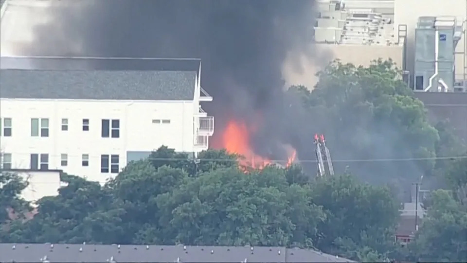 Flames engulf an apartment complex after an explosion in the Oak Cliff area of Dallas on Thursday as Dallas Fire-Rescue crews battled the blaze. Four people were hospitalized, according to reports. (KDFW FOX 4 via AP)