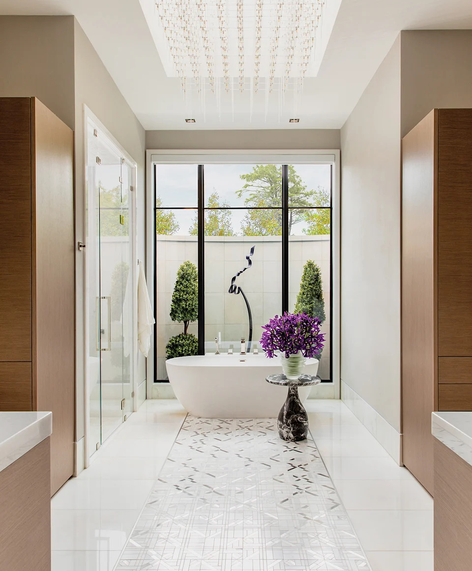 A custom lighting installation by Zaneen casts the bath in a gallerylike glow, and an outdoor sculpture by Meredith “Butch” Jack serves as a playful exclamation point through the window.