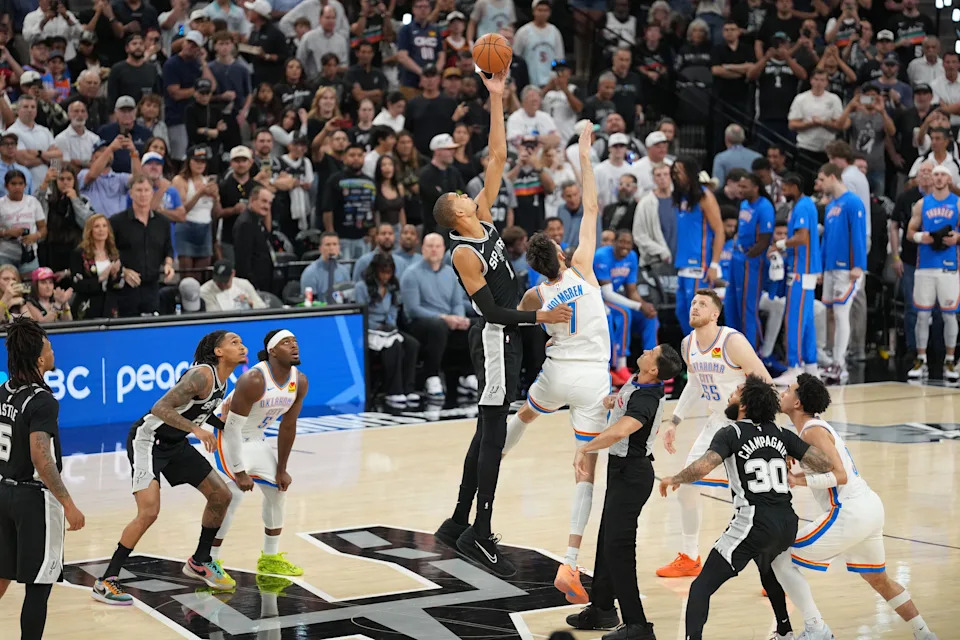 May 28, 2026; San Antonio, Texas, USA; San Antonio Spurs forward Victor Wembanyama (1) tips the opening tip-off against Oklahoma City Thunder center Chet Holmgren (7) in game six of the western conference finals for the 2026 NBA playoffs at Frost Bank Center. Mandatory Credit: Daniel Dunn-Imagn Images