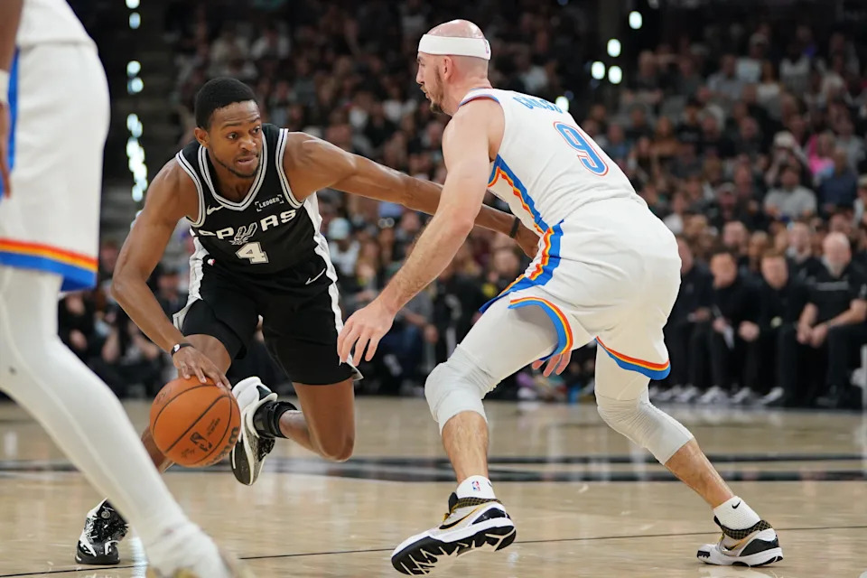May 28, 2026; San Antonio, Texas, USA; San Antonio Spurs guard De'aaron Fox (4) dribbles the ball against Oklahoma City Thunder guard Alex Caruso (9) in the first half during game six of the western conference finals for the 2026 NBA playoffs at Frost Bank Center. Mandatory Credit: Dustin Safranek-Imagn Images