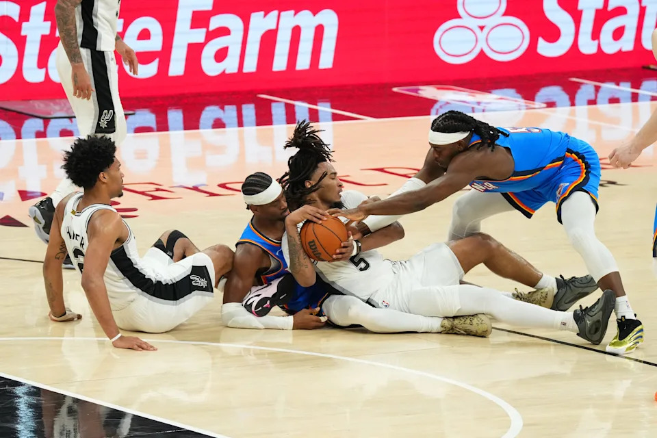 May 24, 2026; San Antonio, Texas, USA; San Antonio Spurs guard Dylan Harper (2), Oklahoma City Thunder guard Shai Gilgeous-Alexander (2), San Antonio Spurs guard Stephon Castle (5) and Oklahoma City Thunder forward Luguentz Dort (5), left to right, scramble for a loose ball in the second quarter during game four of the western conference finals for the 2026 NBA playoffs at Frost Bank Center. Mandatory Credit: Scott Wachter-Imagn Images