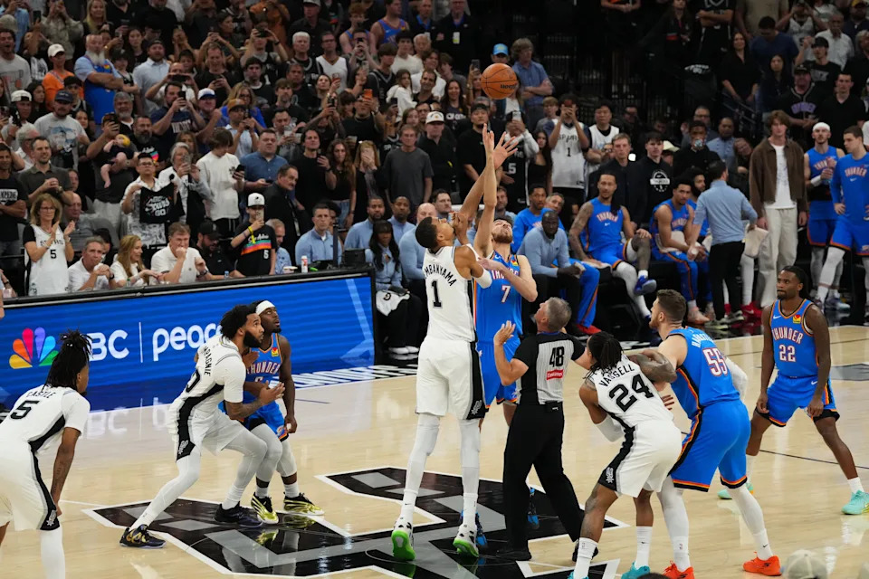 May 24, 2026; San Antonio, Texas, USA; San Antonio Spurs center Victor Wembanyama (1) and Oklahoma City Thunder center Chet Holmgren (7) tip off game four of the western conference finals for the 2026 NBA playoffs at Frost Bank Center. Mandatory Credit: Scott Wachter-Imagn Images