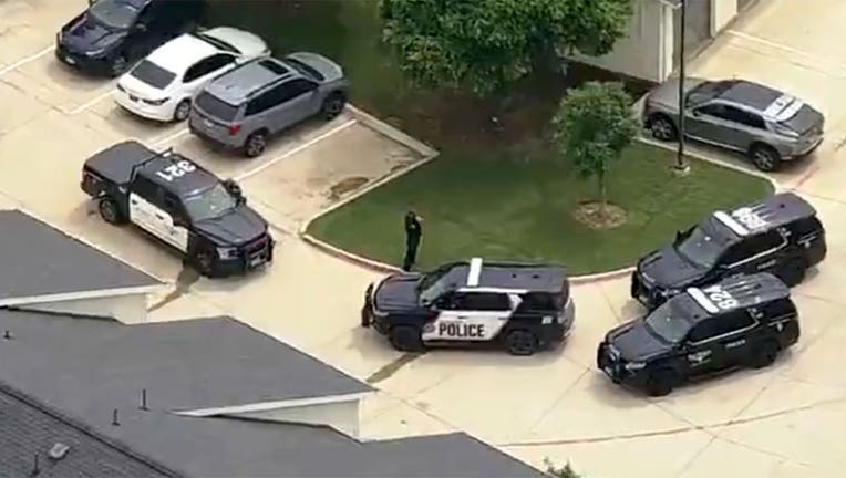 Police vehicles are seen at an apartment complex in the Fort Worth, Texas, area on May 5, 2026.