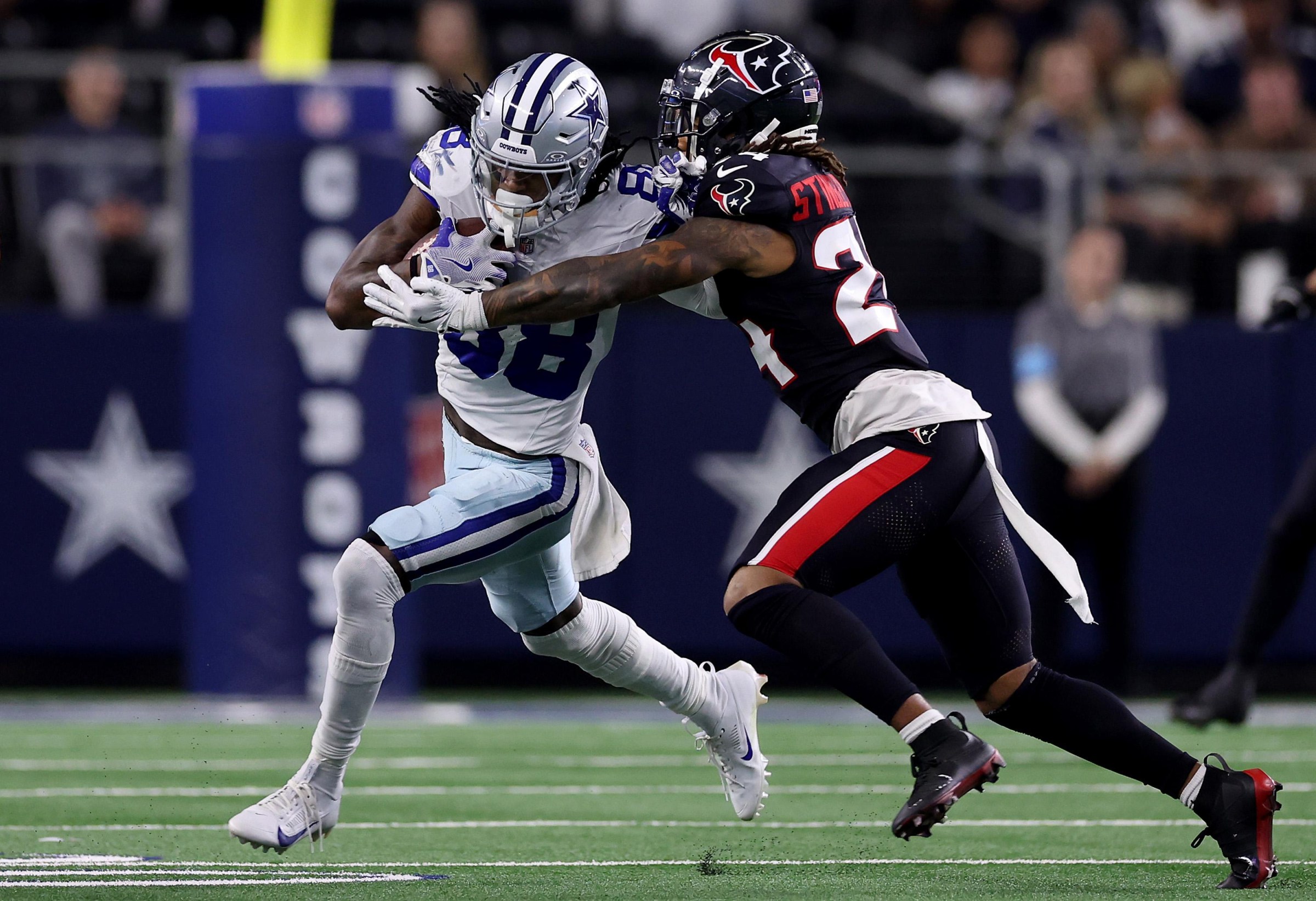 ARLINGTON, TEXAS - NOVEMBER 18: CeeDee Lamb #88 of the Dallas Cowboys runs the ball against Derek Stingley Jr. #24 of the Houston Texans during the third quarter in the game at AT&T Stadium on November 18, 2024 in Arlington, Texas. (Photo by Sam Hodde/Getty Images)