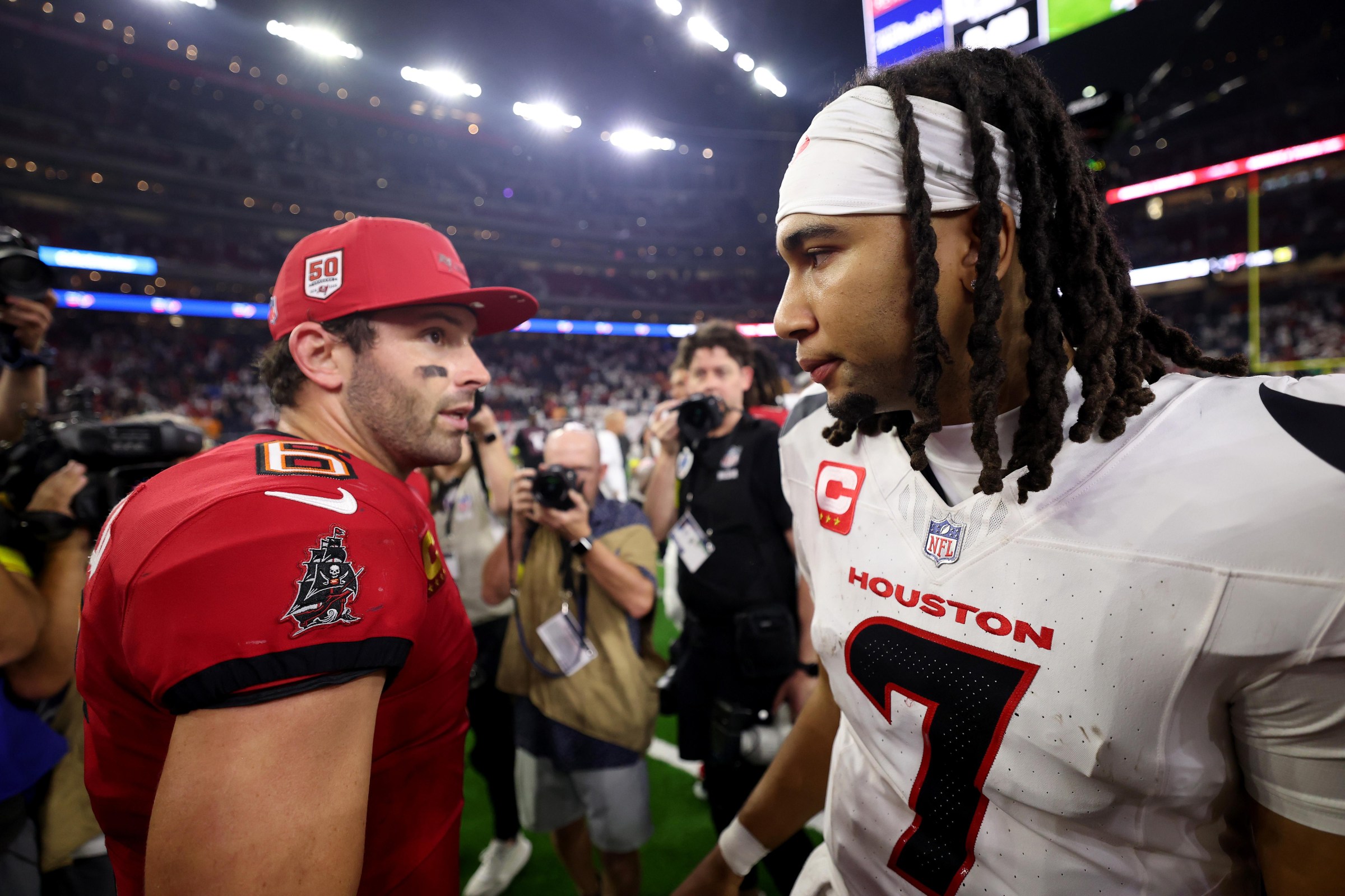 HOUSTON, TEXAS - SEPTEMBER 15: C.J. Stroud #7 of the Houston Texans congratulates Baker Mayfield #6 of the Tampa Bay Buccaneers after the game at NRG Stadium on September 15, 2025 in Houston, Texas. (Photo by Tim Warner/Getty Images)