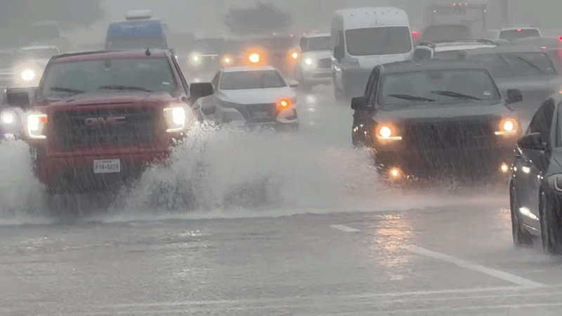 Drivers Push Through Flooded Road in Houston Suburbs