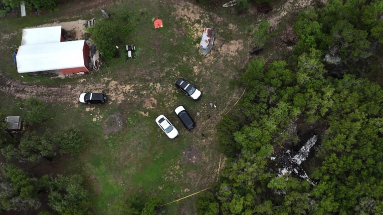 A crashed Cessna airplane is seen in a wooded area...