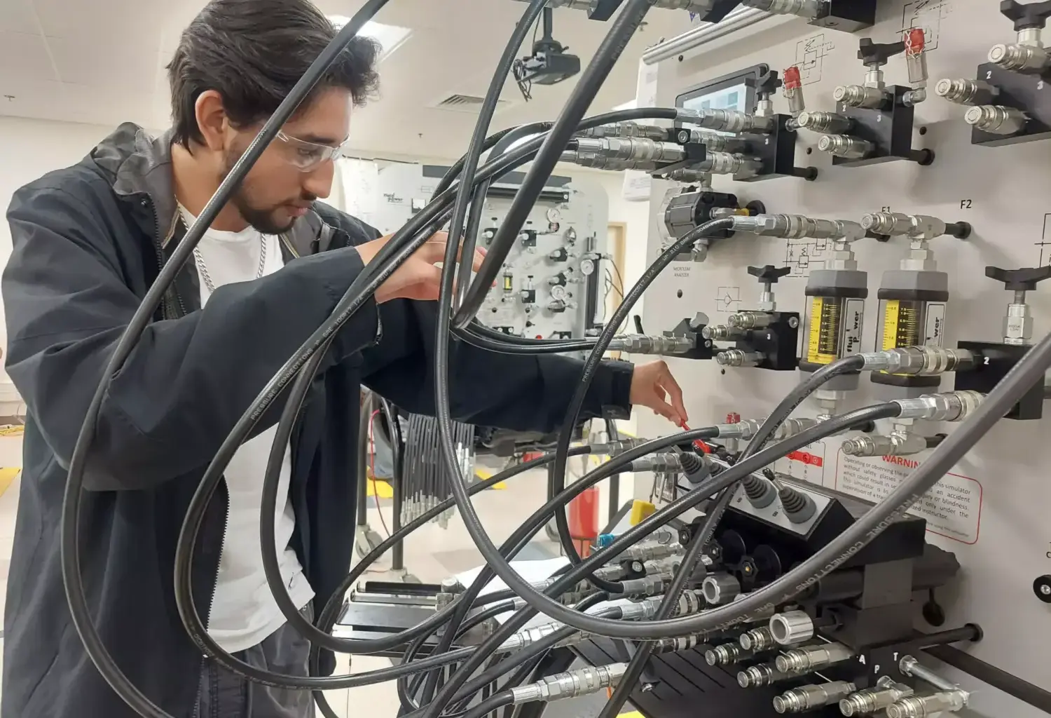 Dylan Ruiz, a 17-year-old senior at Legacy High School in Midland, works through a training scenario on preventing oil leaks during his class on pumps, compressors and mechanical drives at Midland College’s Petroleum Energy Program.