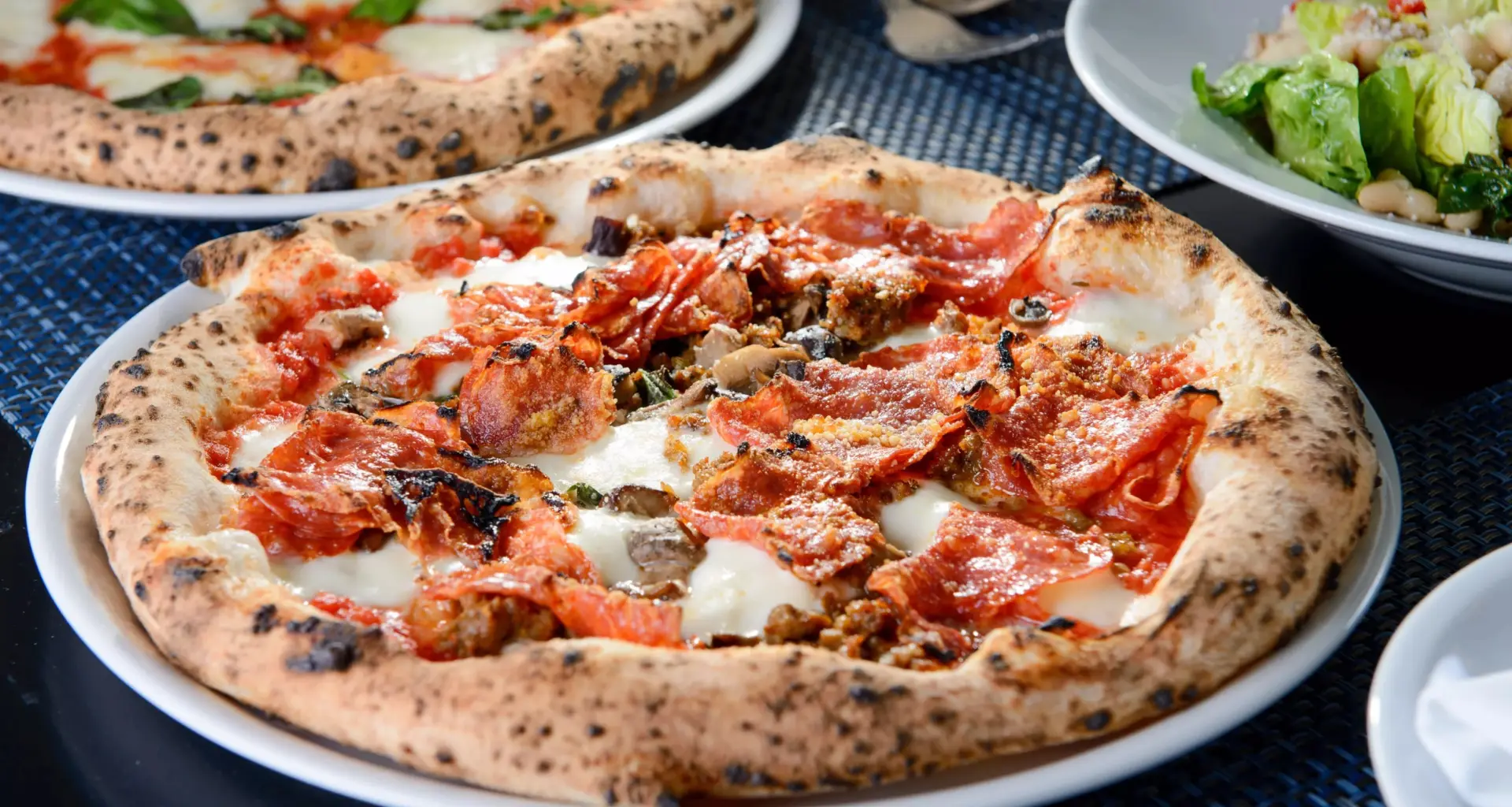 Pizza at Partenope with mozzarella, pecorino, tomato sauce, soppressata, Jimmy's sausages, mushrooms and basil.
