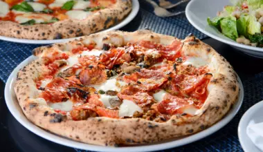 Pizza at Partenope with mozzarella, pecorino, tomato sauce, soppressata, Jimmy's sausages, mushrooms and basil.