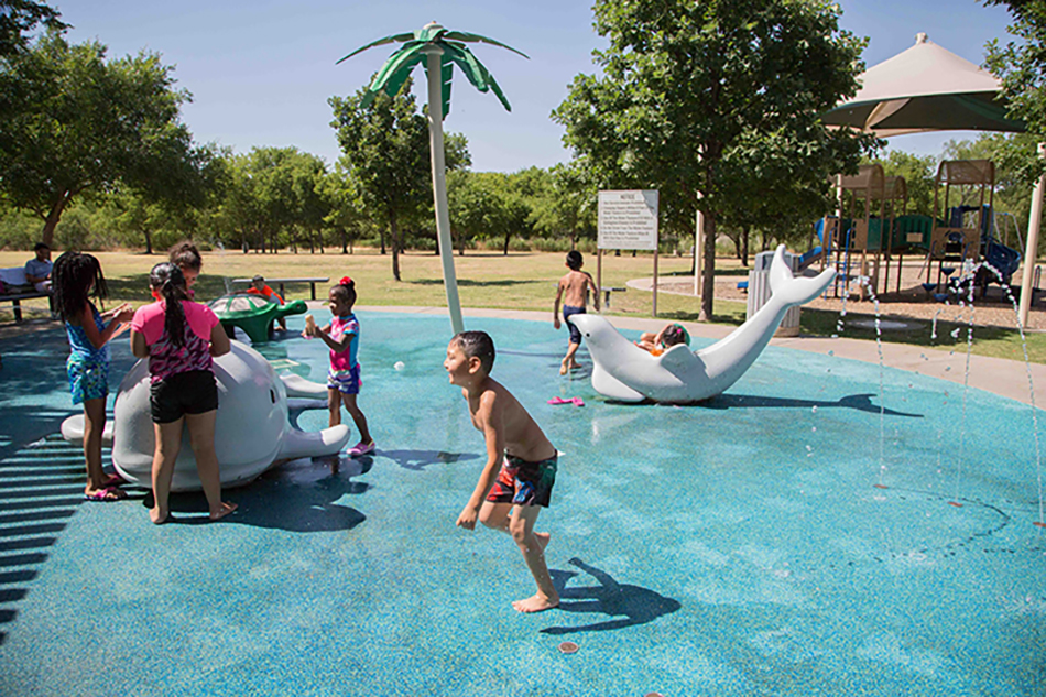 Children playing on water features at Don Misenhimer Park splash pad